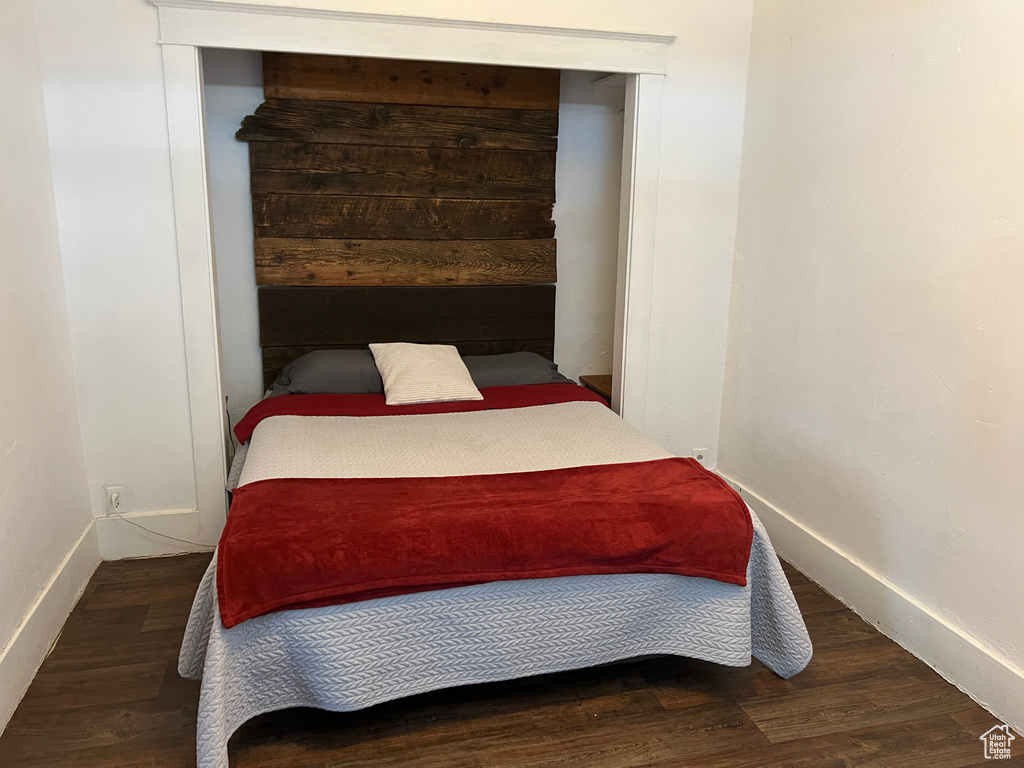 Bedroom with dark wood-type flooring