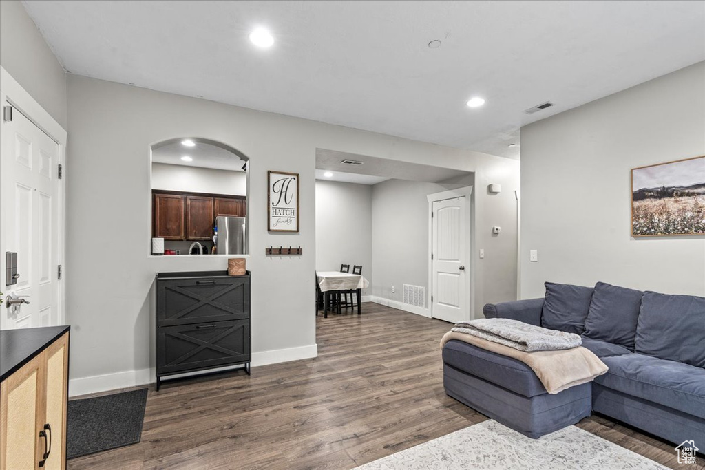 Living room with dark wood-type flooring