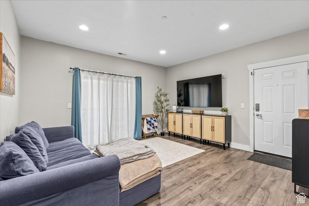 Living room with light hardwood / wood-style flooring