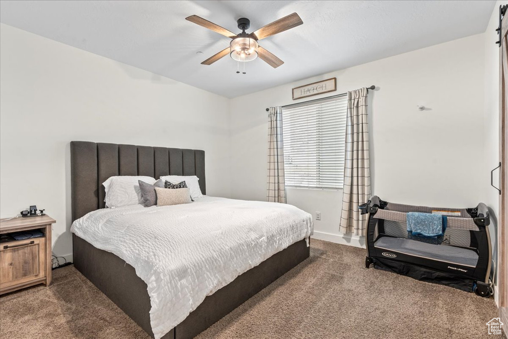 Carpeted bedroom with ceiling fan