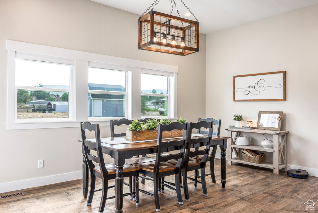 Dining room featuring a notable chandelier and hardwood / wood-style flooring
