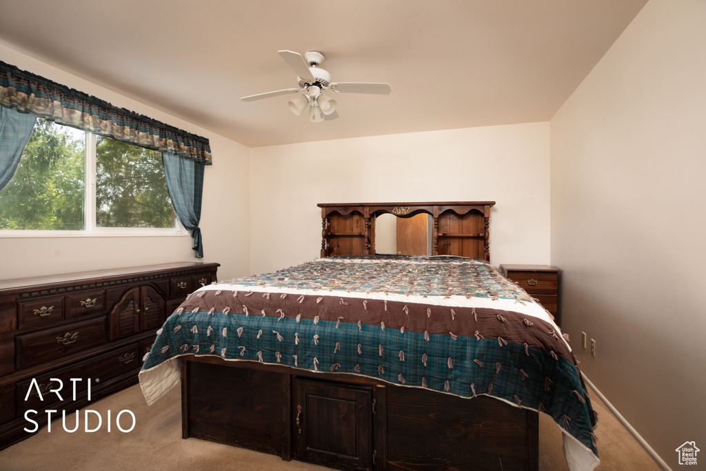 Carpeted bedroom with ceiling fan
