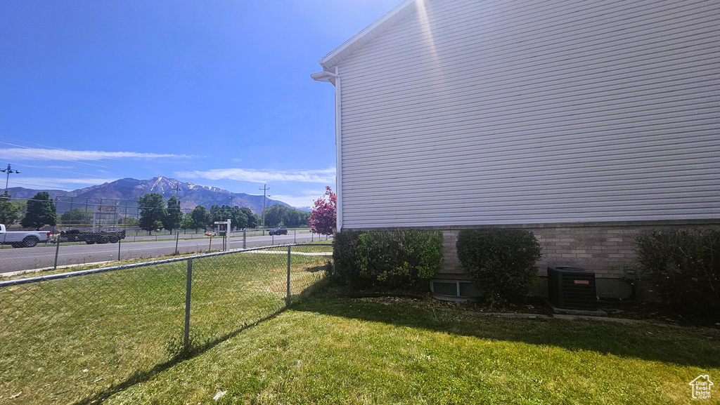 View of yard with a mountain view and central air condition unit