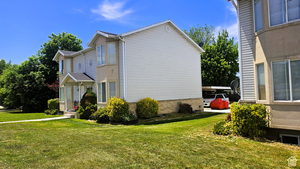 View of side of property with a yard