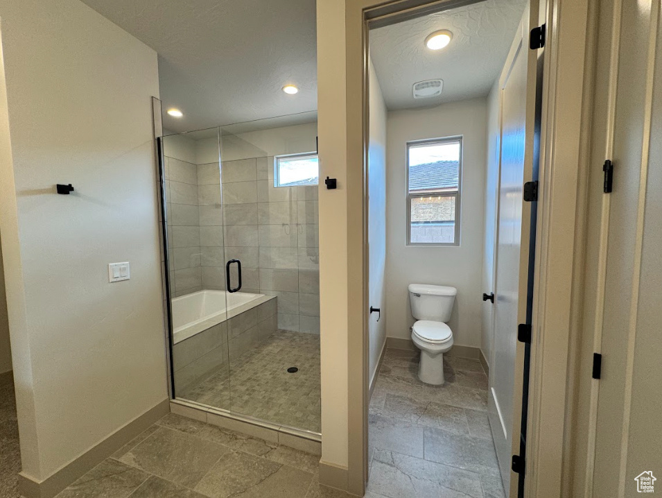 Bathroom featuring baseboards, recessed lighting, toilet, and a shower stall