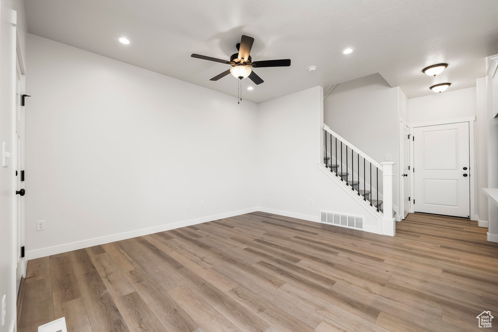 Empty room featuring ceiling fan and light wood-type flooring