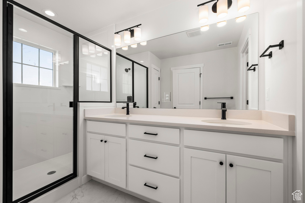 Bathroom featuring walk in shower and vanity