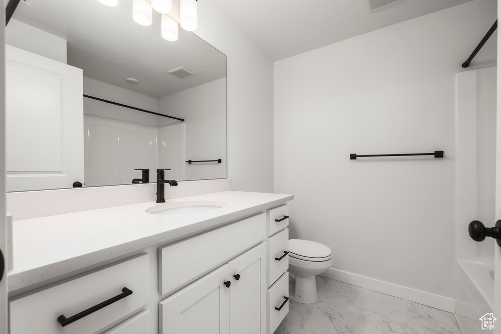 Full bathroom featuring shower / bathtub combination, vanity, and toilet