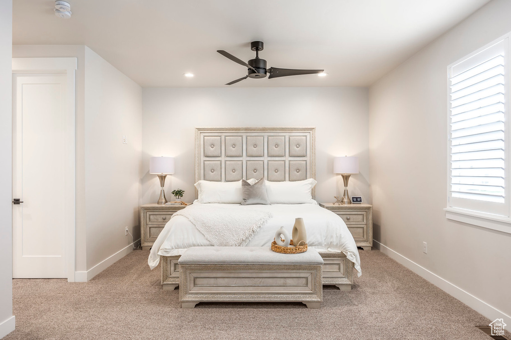 Carpeted bedroom with ceiling fan
