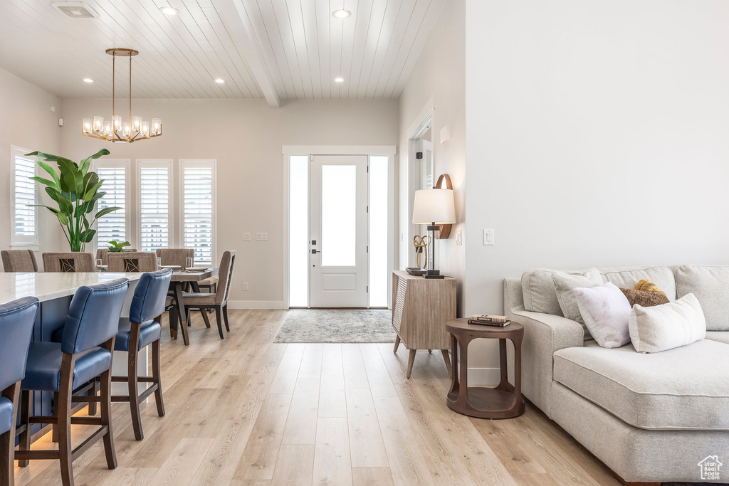 Interior space with an inviting chandelier, wooden ceiling, and light wood-type flooring