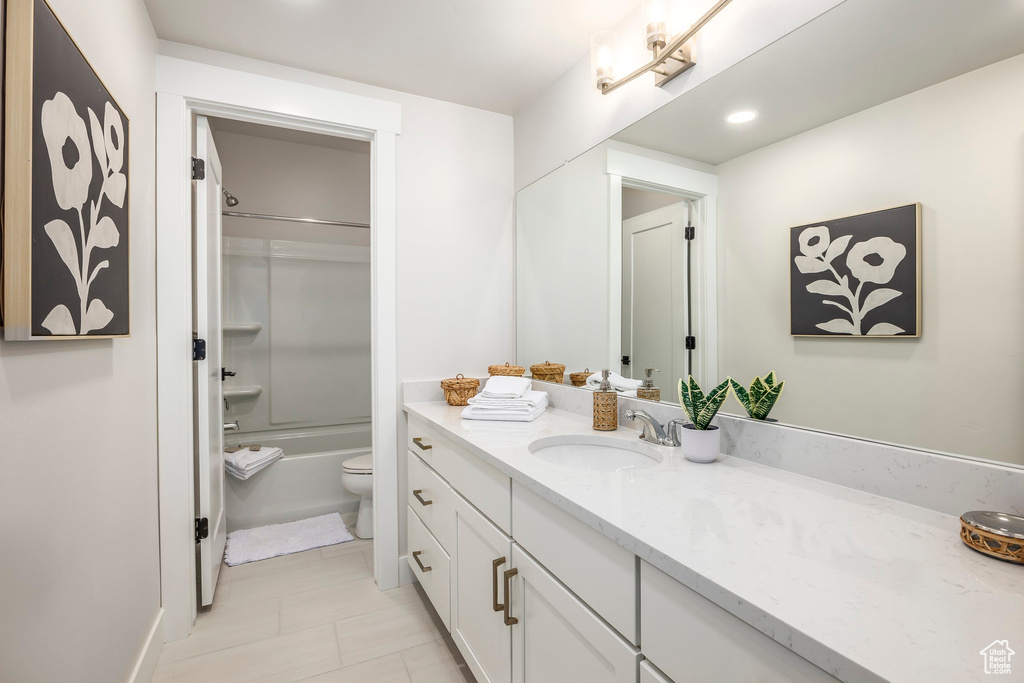 Full bathroom featuring vanity, toilet, tile patterned floors, and shower / bathing tub combination