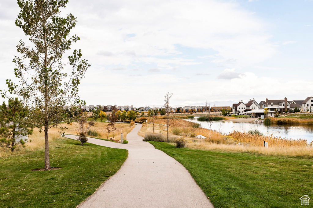 Surrounding community featuring a yard and a water view