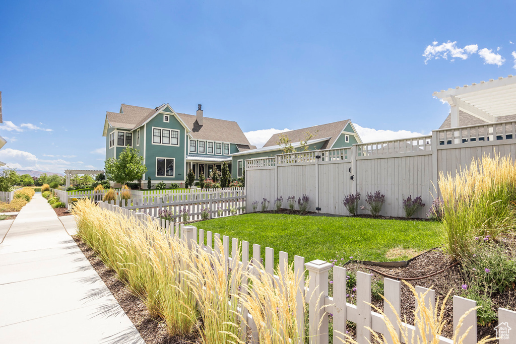 Exterior space featuring a front yard and a pergola