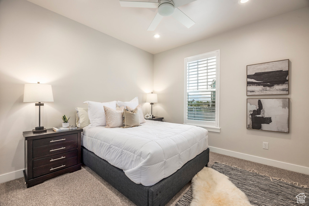 Bedroom featuring light carpet and ceiling fan
