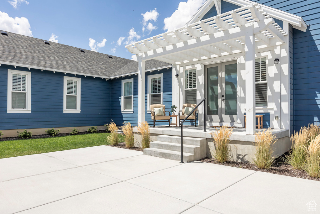 Exterior space featuring french doors, a pergola, and a patio