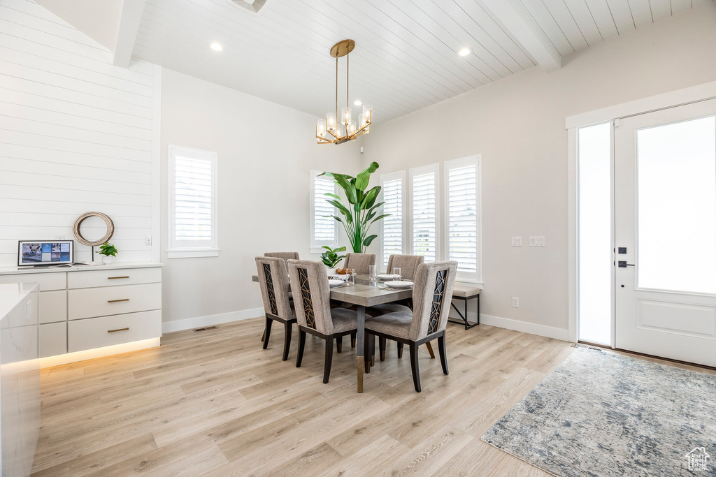Dining area featuring wood ceiling, light hardwood / wood-style flooring, a chandelier, and beamed ceiling