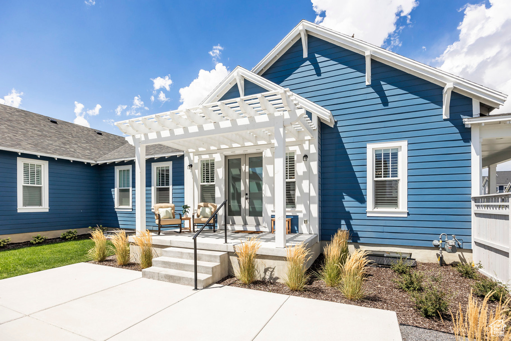 Rear view of house featuring a pergola and a patio