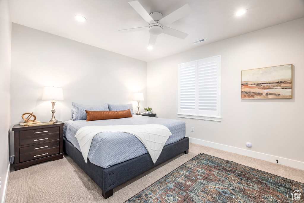 Bedroom featuring light carpet and ceiling fan
