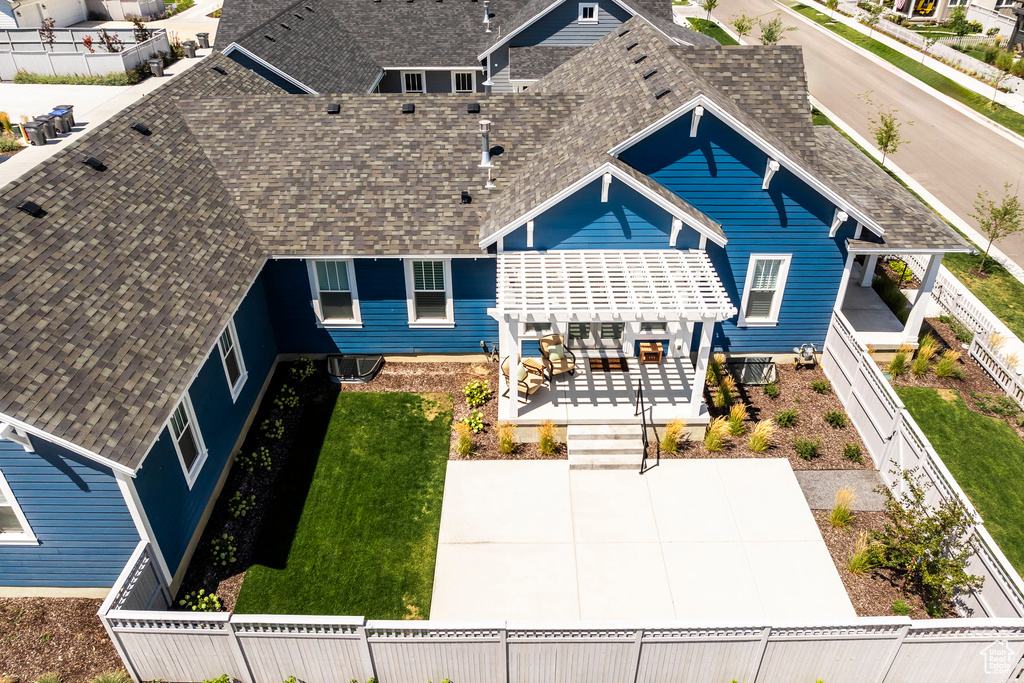 Exterior space featuring a front yard, a patio area, and a pergola