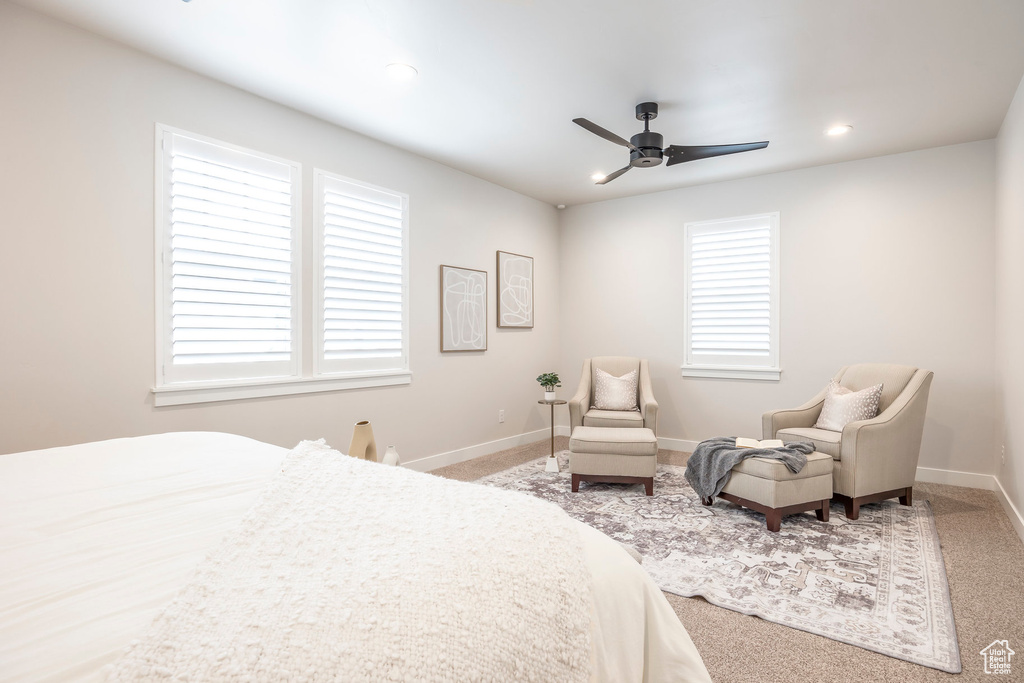 Carpeted bedroom featuring ceiling fan