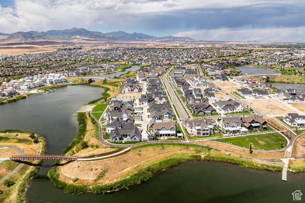 Birds eye view of property with a water and mountain view