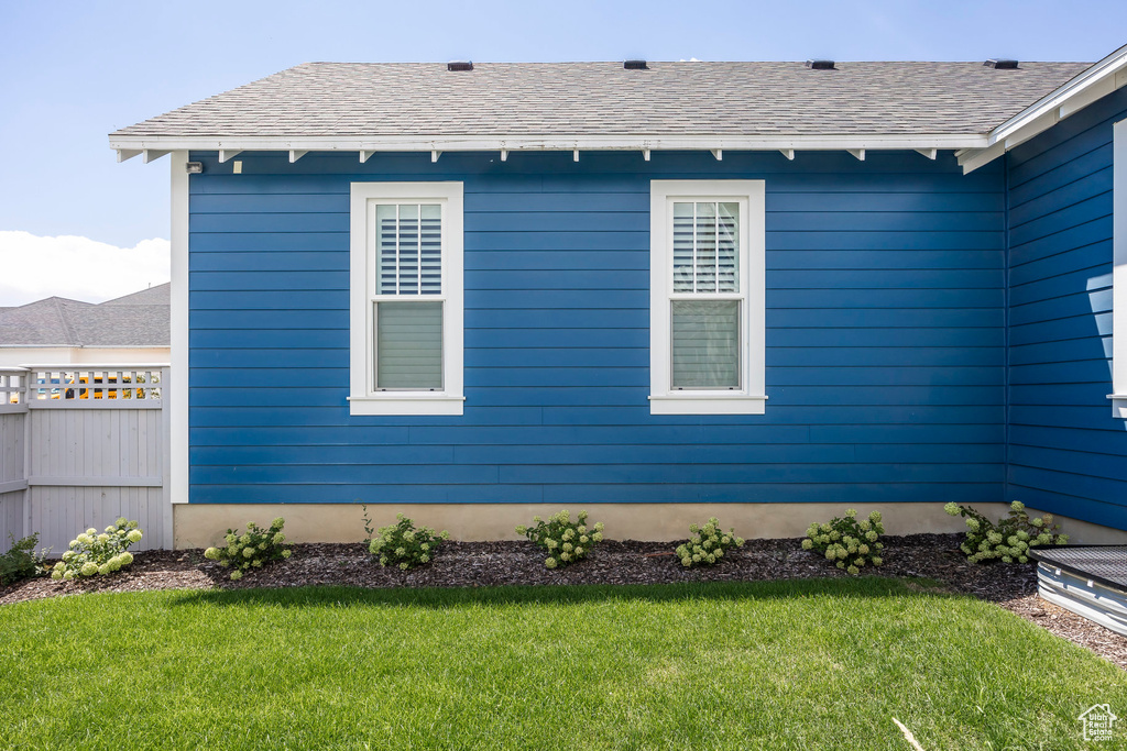 View of side of home with a lawn