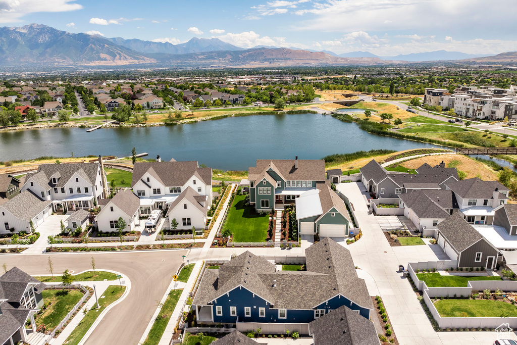 Birds eye view of property featuring a water and mountain view