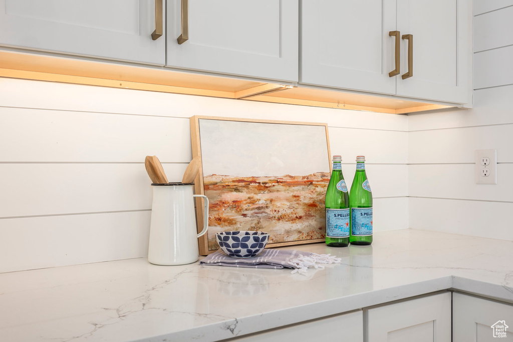 Details featuring light stone countertops and white cabinets