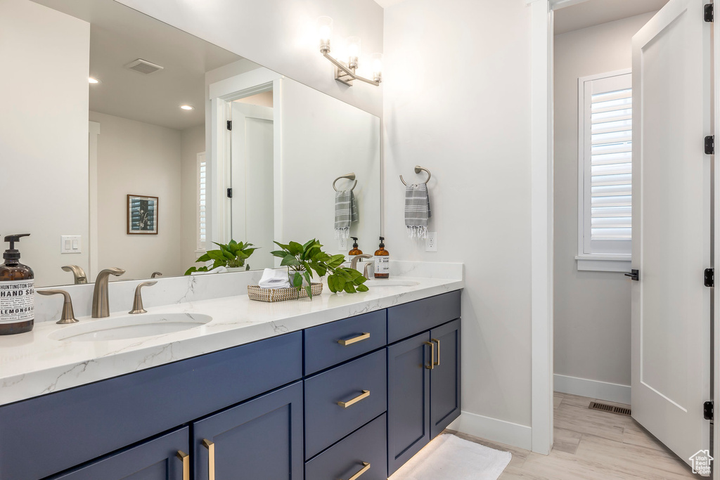 Bathroom with hardwood / wood-style flooring and vanity