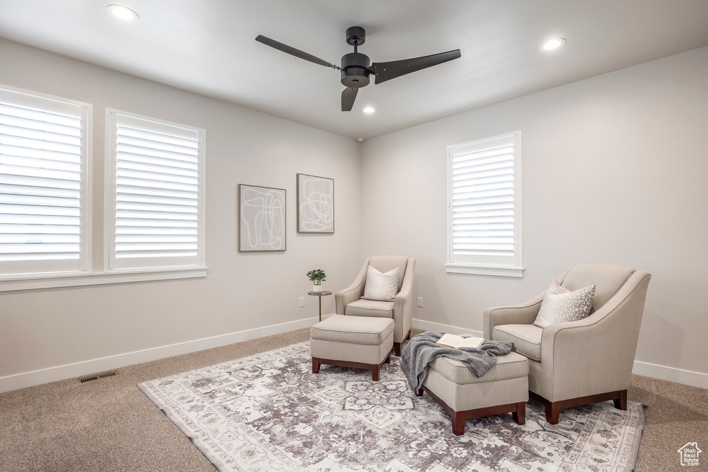 Sitting room with ceiling fan and light carpet