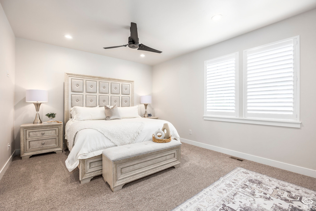 Carpeted bedroom with ceiling fan