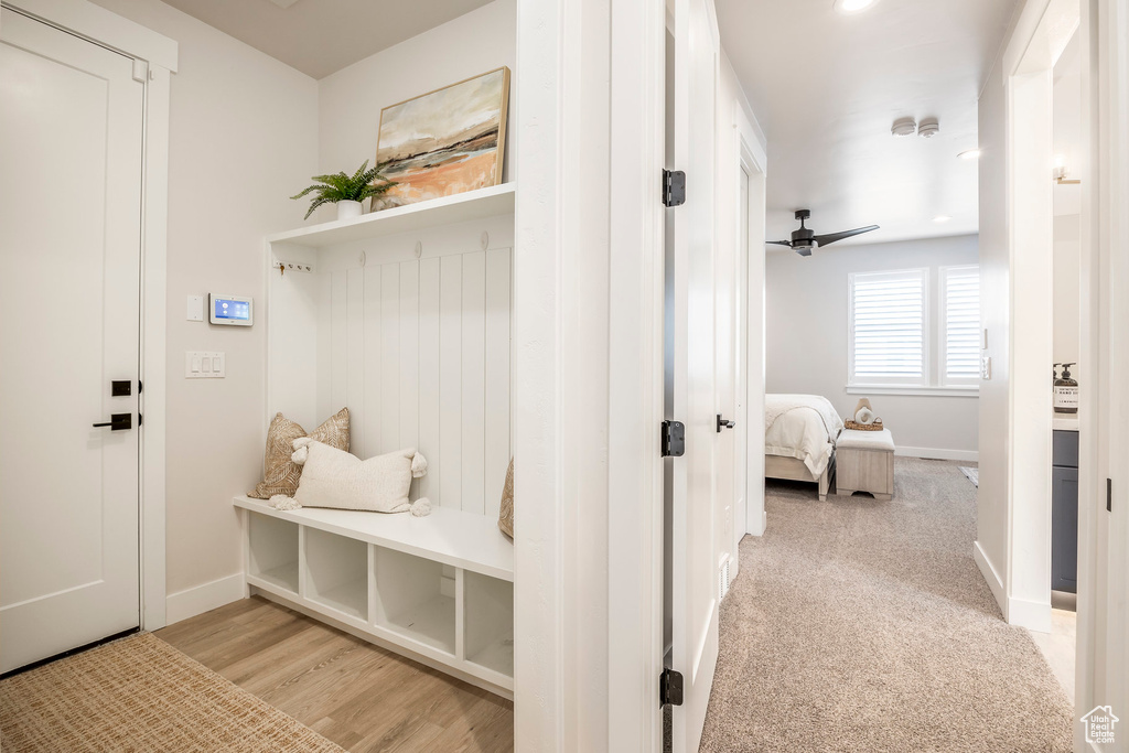 Mudroom with ceiling fan and light hardwood / wood-style flooring