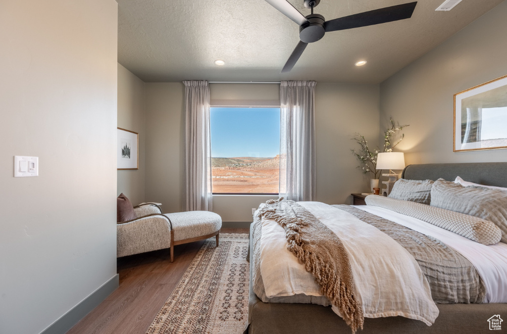 Bedroom featuring baseboards, recessed lighting, a ceiling fan, and wood finished floors