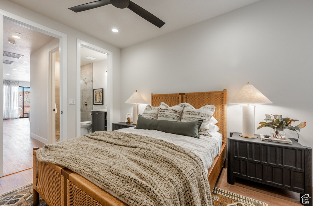 Bedroom featuring wood finished floors, connected bathroom, a ceiling fan, and recessed lighting