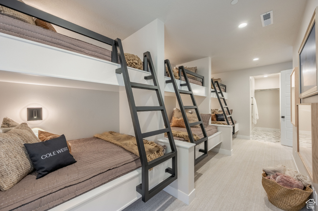 Bedroom with light colored carpet, recessed lighting, and baseboards