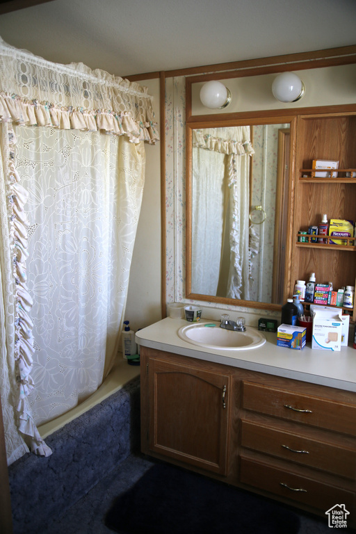 Bathroom featuring vanity and shower / tub combo