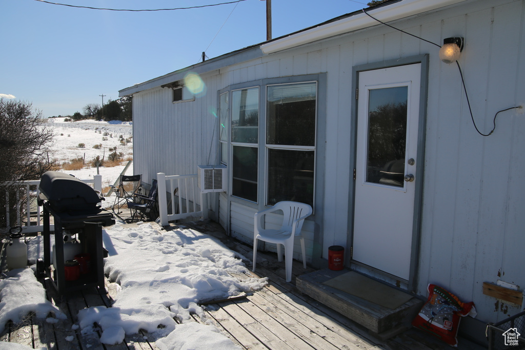 Snow covered deck featuring grilling area