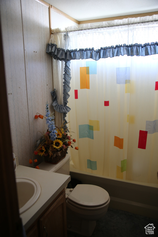 Full bathroom with shower / bathtub combination with curtain, vanity, and toilet
