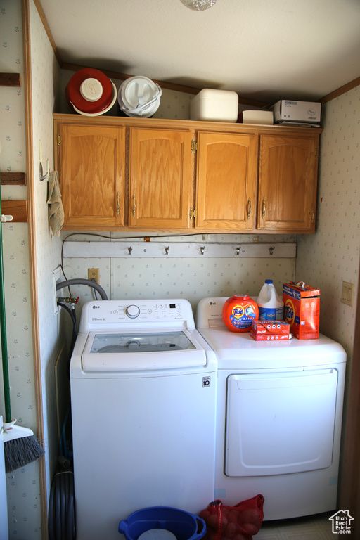 Laundry room with cabinets and washer and dryer