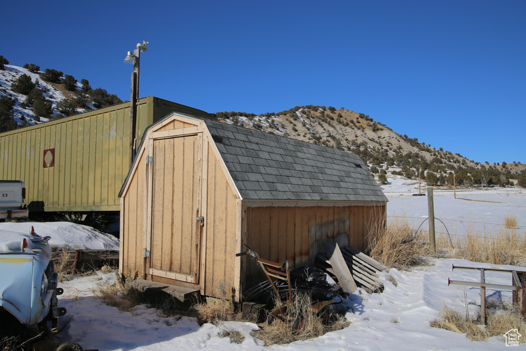 Snow covered structure with a mountain view