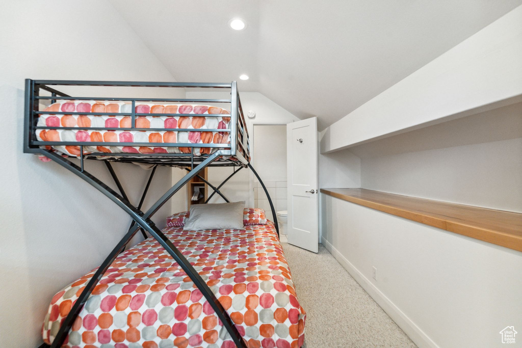 Carpeted bedroom featuring vaulted ceiling, baseboards, and recessed lighting