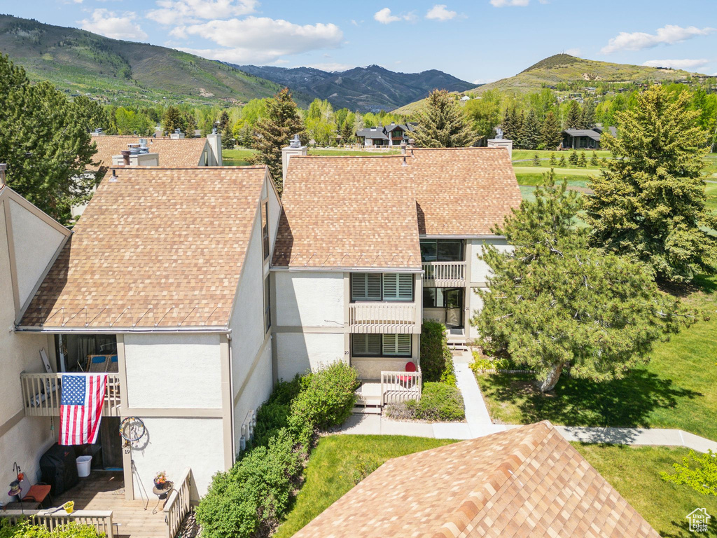 Aerial view of property and surrounding area featuring mountains