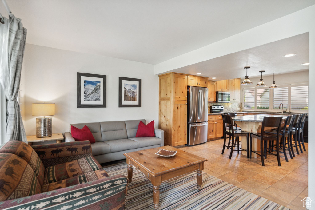 Living area featuring recessed lighting and light tile patterned floors