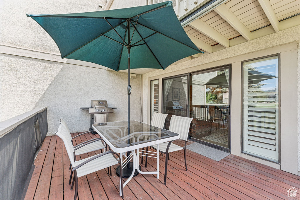 Deck featuring outdoor dining space and grilling area