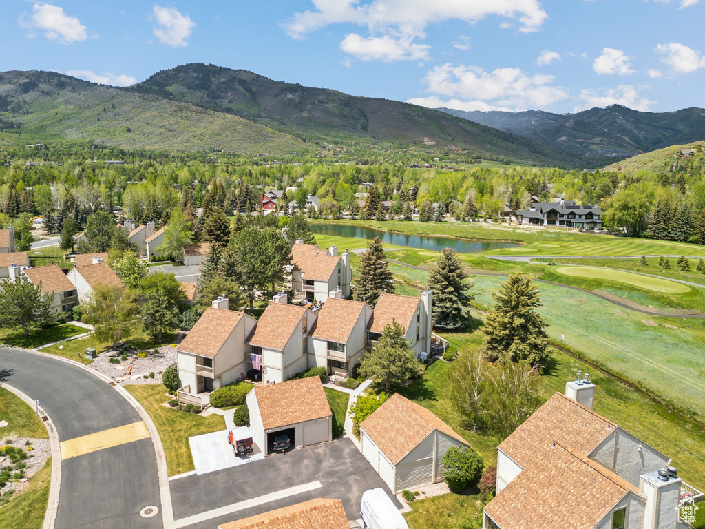 Aerial view of residential area featuring a water and mountain view and a golf course