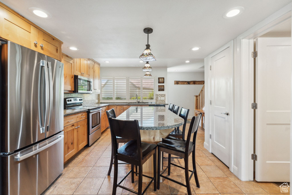 Dining space featuring light tile patterned flooring and recessed lighting