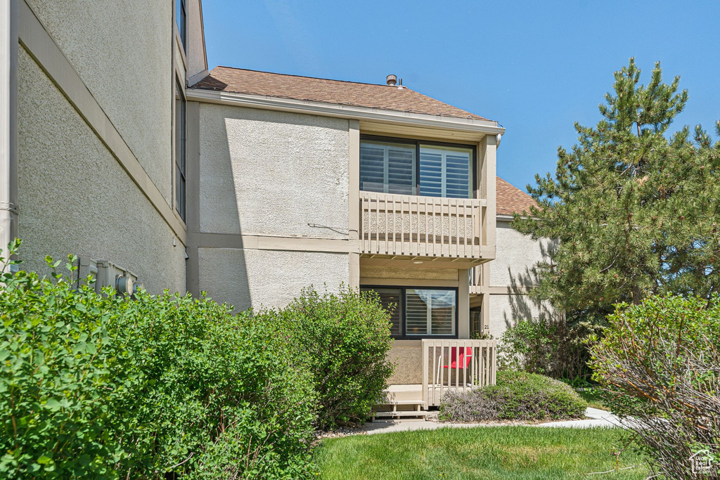 Back of property featuring stucco siding
