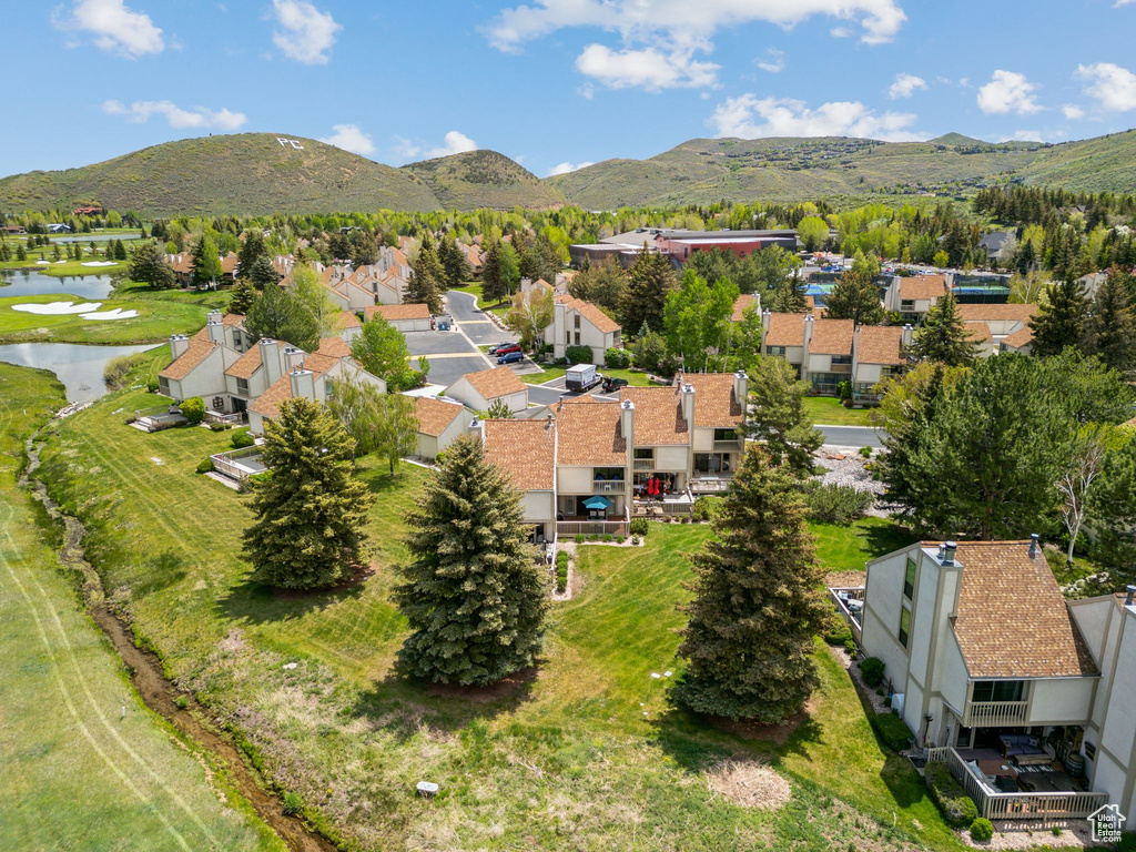 View of property location featuring a water and mountain view and nearby suburban area