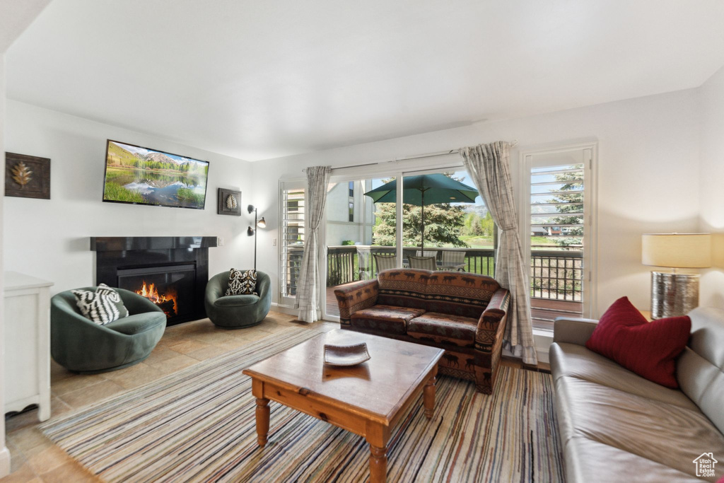 Living area featuring a lit fireplace