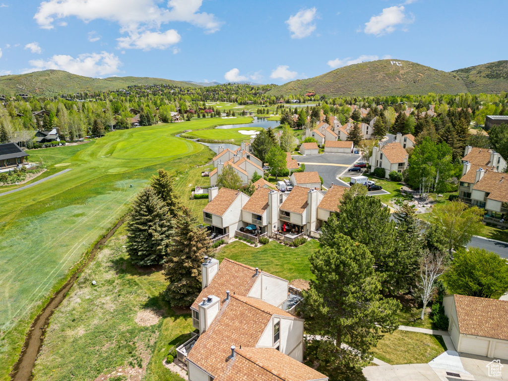 Aerial view of residential area with a water and mountain view and a golf course